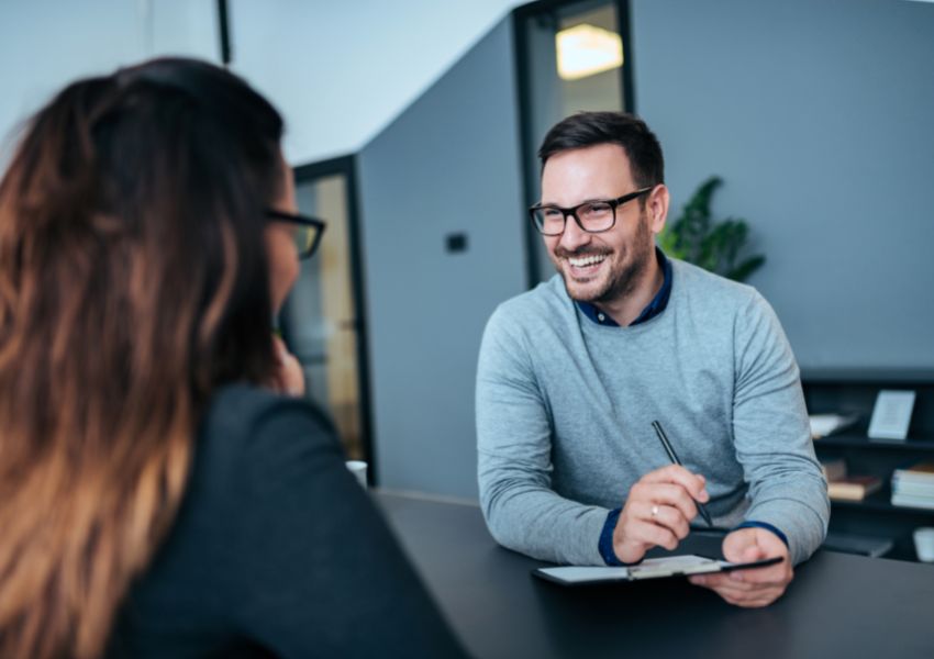 pair-sitting-across-a-table-smiling