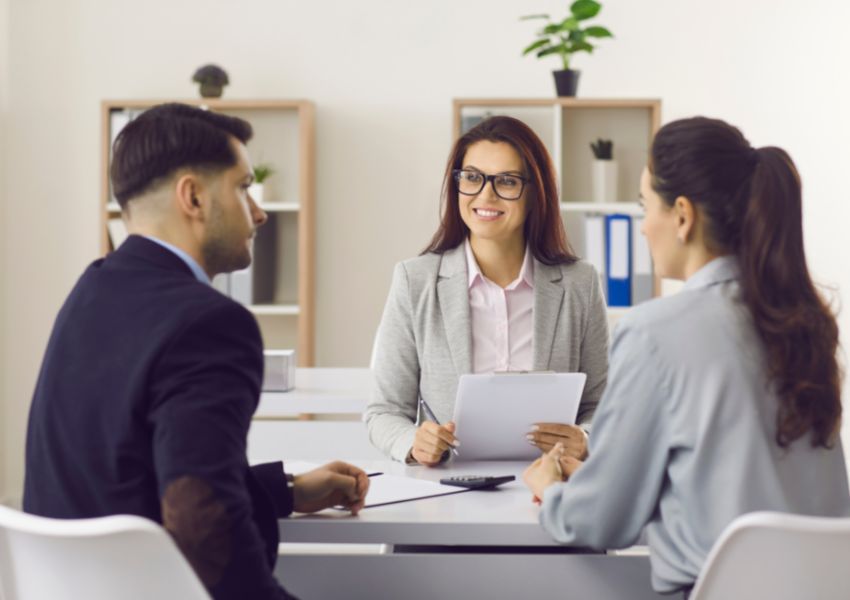two-people-sitting-across-from-property-manager