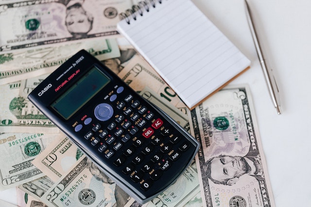 a calculator sitting on paper money