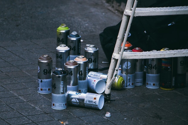 spray paint cans next to a ladder