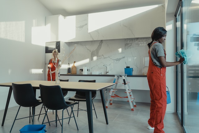 two professionals cleaning a kitchen