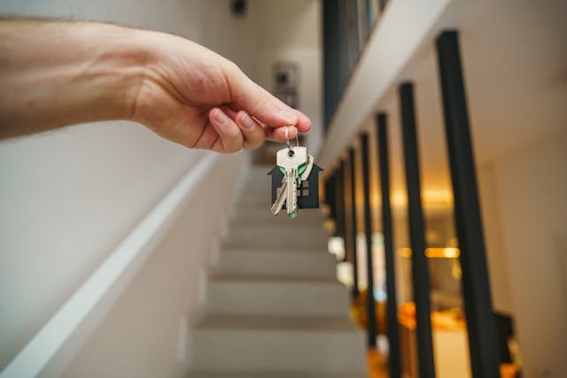 person holding up set of keys